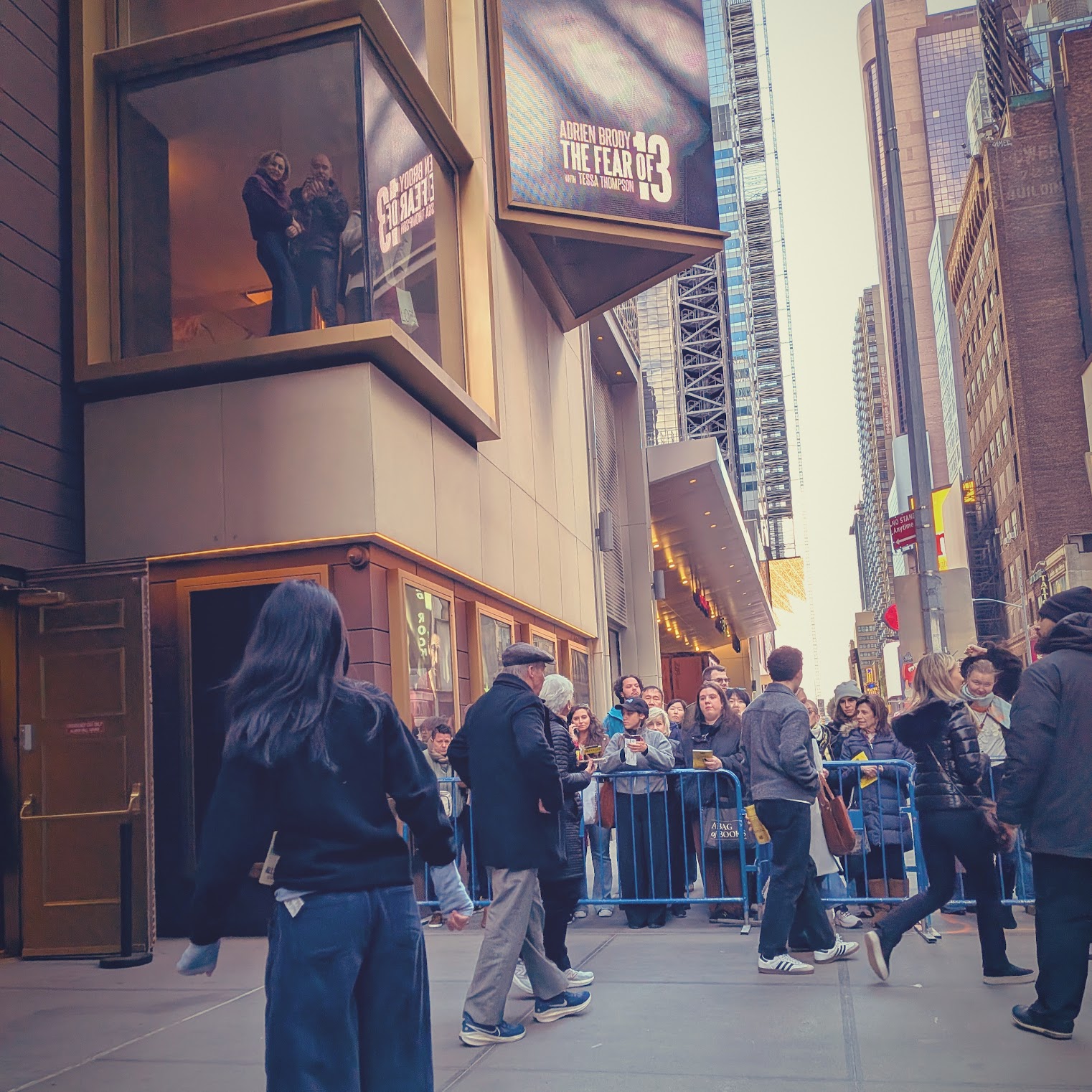 The stage door of the Fear of 13 production, with crowd-control barriers along the pavement.